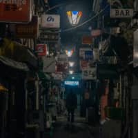 Located to the northeast of Shinjuku Station, Golden Gai is popular with tourists, but its crowded, small and poorly ventilated bars are the stuff of an epidemiologists nightmare. So it was unsurprising to see the bars shut during the state of emergency. The crowds were gone, the bar lights off and only the faint smell of stale alcohol remained. | OSCAR BOYD
