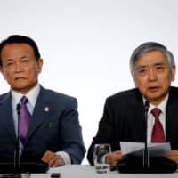 In a rare joint statement last week, BOJ Gov. Haruhiko Kuroda and Finance Minister Taro Aso pledged to work hand in glove to facilitate the nation\'s economic recovery. | REUTERS