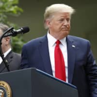 U.S. President Donald Trump pauses after speaking during a news conference in the Rose Garden of the White House in Washington on Friday. | BLOOMBERG