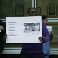 Hospital workers hold placards with the names of their colleagues who have died from coronavirus as they take part in a protest in London on Tuesday calling on the British government to provide personal protective equipment across Britain for all workers in the National Health Service and other vital public services. | AP