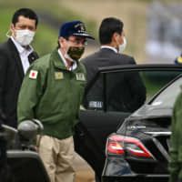 Defense Minister Taro Kono wears a protective face mask while attending a Ground Self-Defense Force live-fire exercise at the East Fuji Maneuver Area in Gotemba, Shizuoka Prefecture, on May 23. | POOL / VIA BLOOMBERG
