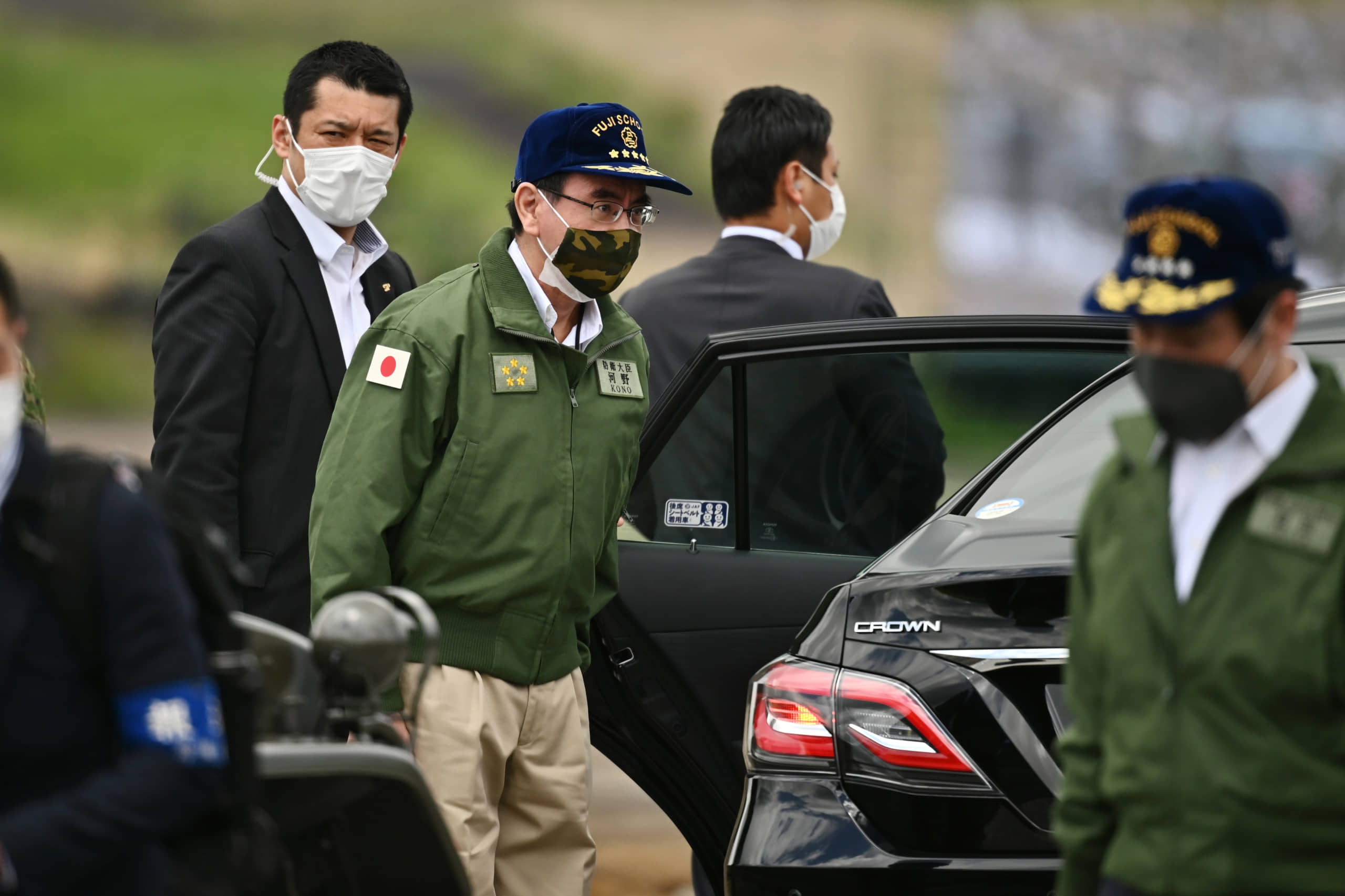 Defense Minister Taro Kono wears a protective face mask while attending a Ground Self-Defense Force live-fire exercise at the East Fuji Maneuver Area in Gotemba, Shizuoka Prefecture, on May 23. | POOL / VIA BLOOMBERG