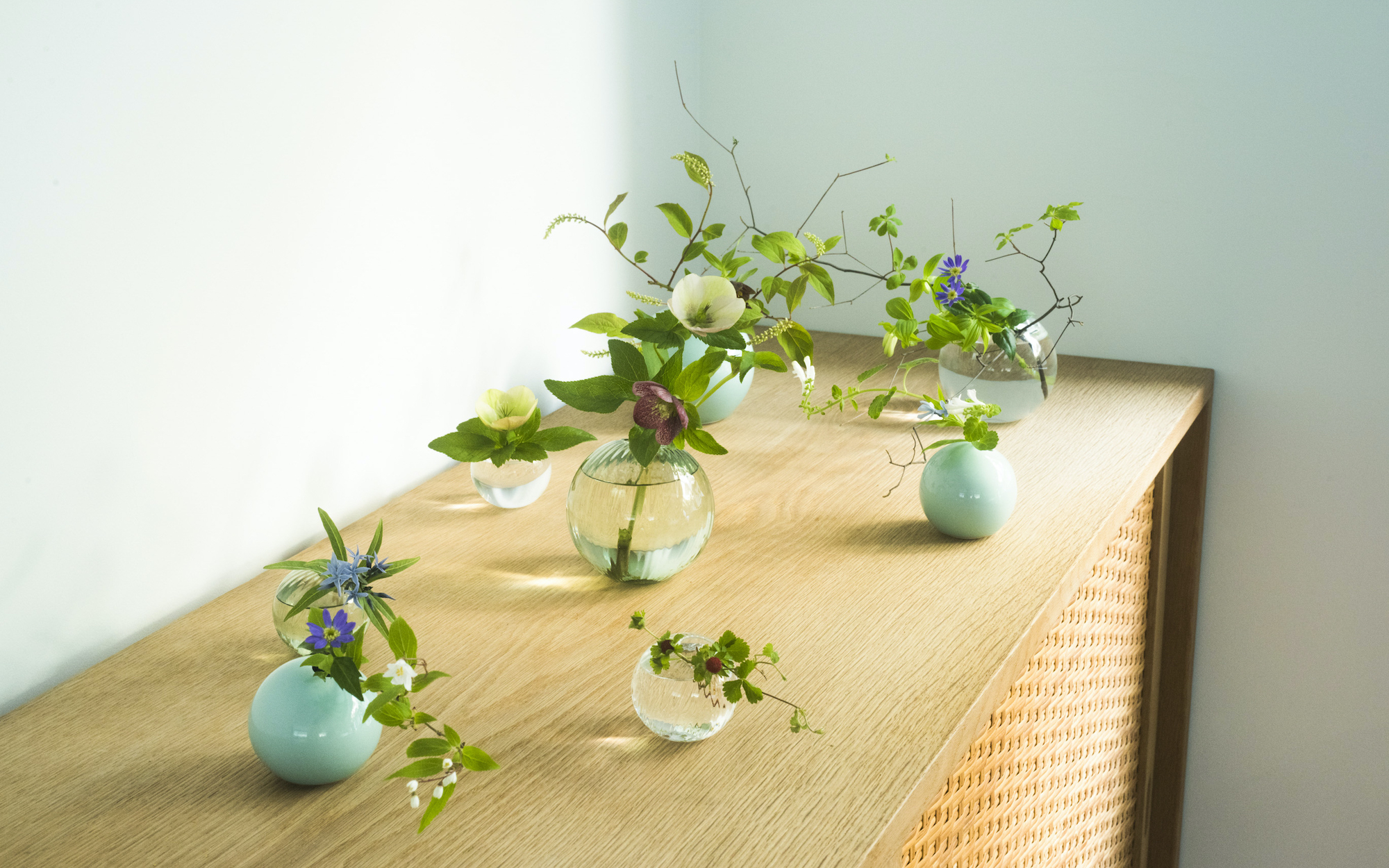 The One Flowerware bud vases are all the same shape, but made in various materials by different artisans. | YUDAI KUSANO