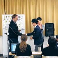 Jun Woo Jung, runner-up of the Canadian International Elementary School Tokyo bee, shakes hands with the school principal, JP Jamieson, in January. | CANADIAN INTERNATIONAL ELEMENTARY SCHOOL TOKYO