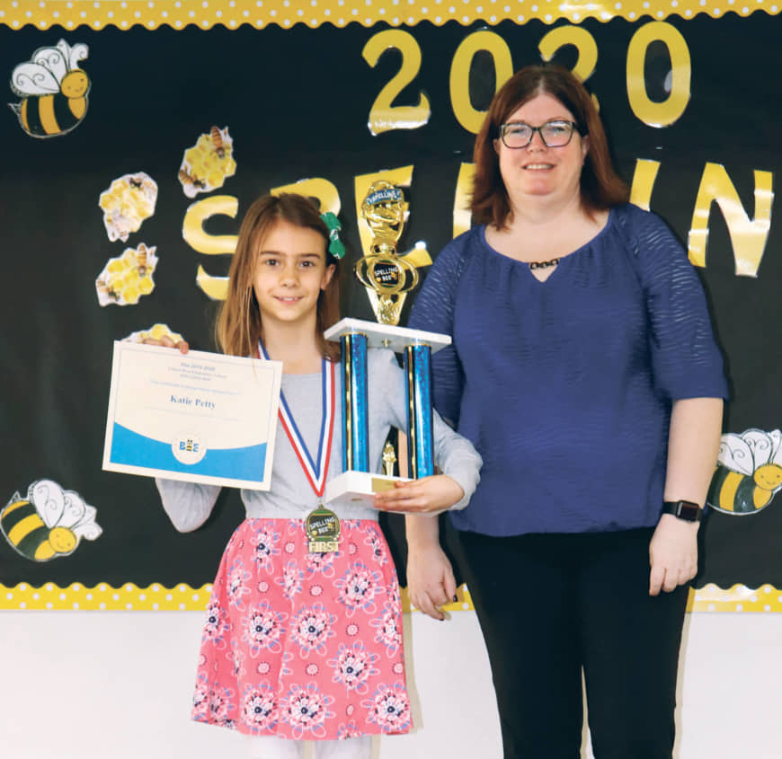Katie Petty holds a trophy and a certificate after the Yokota West Elementary School bee. | YOKOTA WEST ELEMENTARY SCHOOL