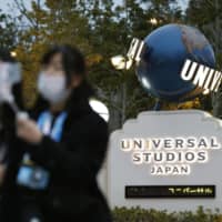 People visit Universal Studios Japan in Osaka on Feb. 28, a day before it was closed to help curb the spread of COVID-19 infections. | KYODO
