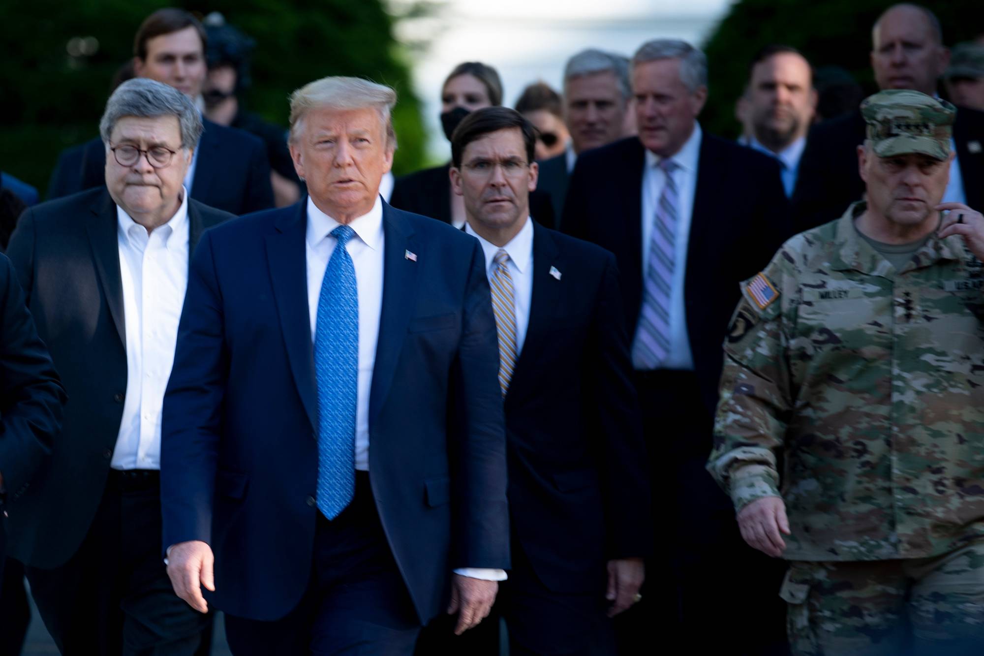 U.S. President Donald Trump walks with Attorney General William Barr (left), Secretary of Defense Mark T. Esper (center), Chairman of the Joint Chiefs of Staff Mark A. Milley (right), and others from the White House on Monday in Washington to visit St. John's Church after the area was cleared of people protesting the death of George Floyd. | AFP-JIJI