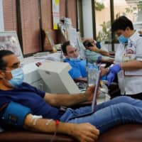 Recovered Israeli COVID-19 patients donate blood samples for plasma extraction Monday, contributing to Israel\'s new experimental antibodies treatment in Sheba Medical Center Hospital near Tel Aviv. | AFP-JIJI