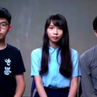Hong Kong pro-democracy activists Joshua Wong (left), Agnes Chow (center) and Au Nok-hin give an online news conference set up by the Foreign Correspondents\' Club of Japan on Wednesday. | JESSE JOHNSON 
