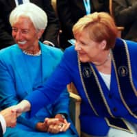 Christine Lagarde, then-head of the International Monetary Fund, and German Chancellor Angela Merkel attend a ceremony in Leipzig, Germany, in August 2019. | REUTERS