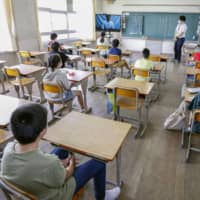Students sit at safe distances from one another at an elementary school in the city of Nara on June 1. | KYODO