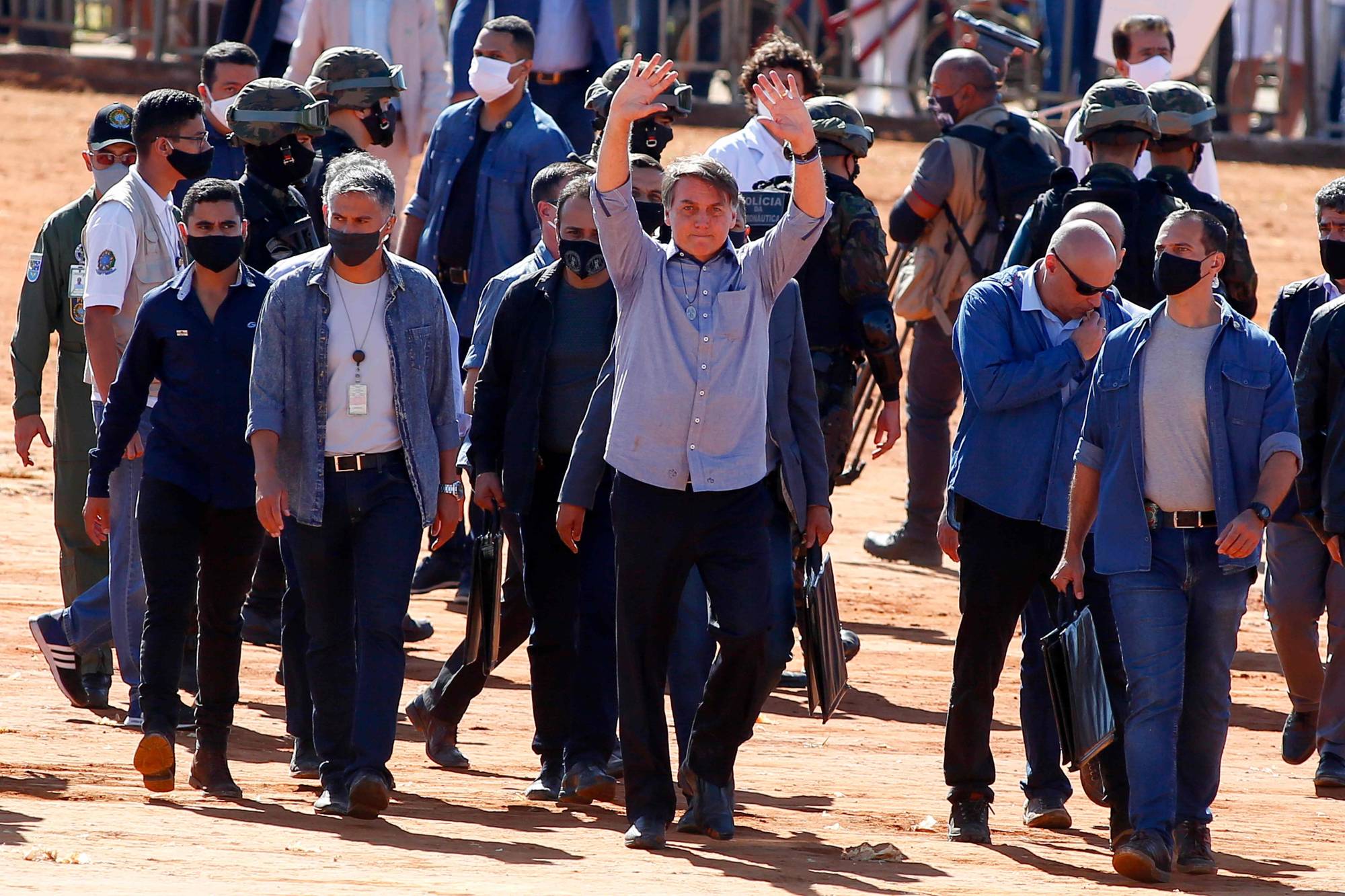 Brazilian President Jair Bolsonaro waves to supporters during the inauguration of a field hospital in Aguas Lindas, Brazil, amid the coronavirus pandemic on Friday.  | AFP-JIJI