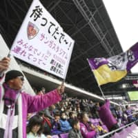 A fan (right) waves a flag resembling a Nazi death\'s head flag during a preseason game between Sanga and Cerezo on Feb. 9 at Sanga Stadium in Kameoka, Kyoto Prefecture. The J. League fined Sanga ¥1 million for the flag on Monday. | KYODO