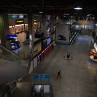 A traveler walks through Guarulhos International Airport in Sao Paulo on May 26. | BLOOMBERG