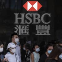 Analysts estimate only around 30 percent of bank staff in Hong Kong can effectively work from home at any one time, meaning a return to the office may be necessary for most. | BLOOMBERG