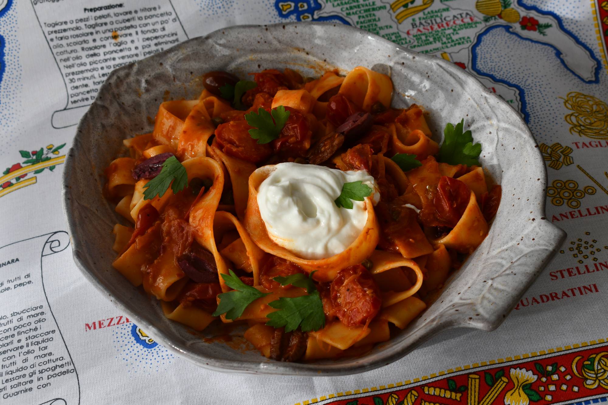 Simply delicious: Harissa chili paste, sweet tomatoes, and briny Kalamata olives and capers make a hearty, addictively spicy sauce for homemade pasta. | SARAH B. HODGE