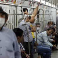 Iranians, mostly wearing face masks, are pictured in a train carriage at a metro station in the capital Tehran on Wednesday. 

 | AFP-JIJI