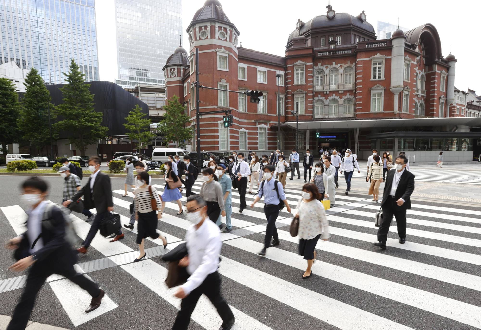 Commuters head to work near Tokyo Station on May 25. | KYODO
