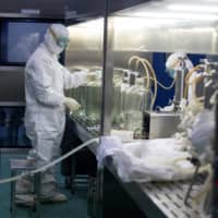 A researcher works in a lab that\'s developing a vaccine for COVID-19 in Shenyang, China.  | AFP-JIJI