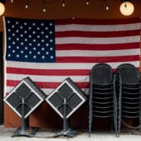 Chairs and tables collect dust in a shuttered New York City restaurant. | AFP-JIJI