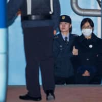 Choi Soon-sil, confidante of South Korea\'s former President Park Geun-hye, is escorted to a prison bus at the Seoul Central District Court in February 2018.  | BLOOMBERG