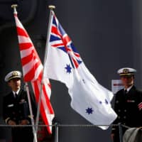 Members of the Maritime Self-Defense Force stand on the deck of the Umigiri destroyer in Sydney before joint exercises between Japan and Australia in April 2016. | REUTERS
