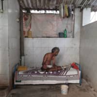 A man rests on his bed in Dharavi, one of Asia\'s largest slums.  | KUNAL KANASE / VIA AP