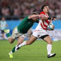 Kenki Fukuoka attempts to evade a tackle by Ireland\'s Keith Earls during their match at the Rugby World Cup on Sept. 28 in Shizuoka. | REUTERS