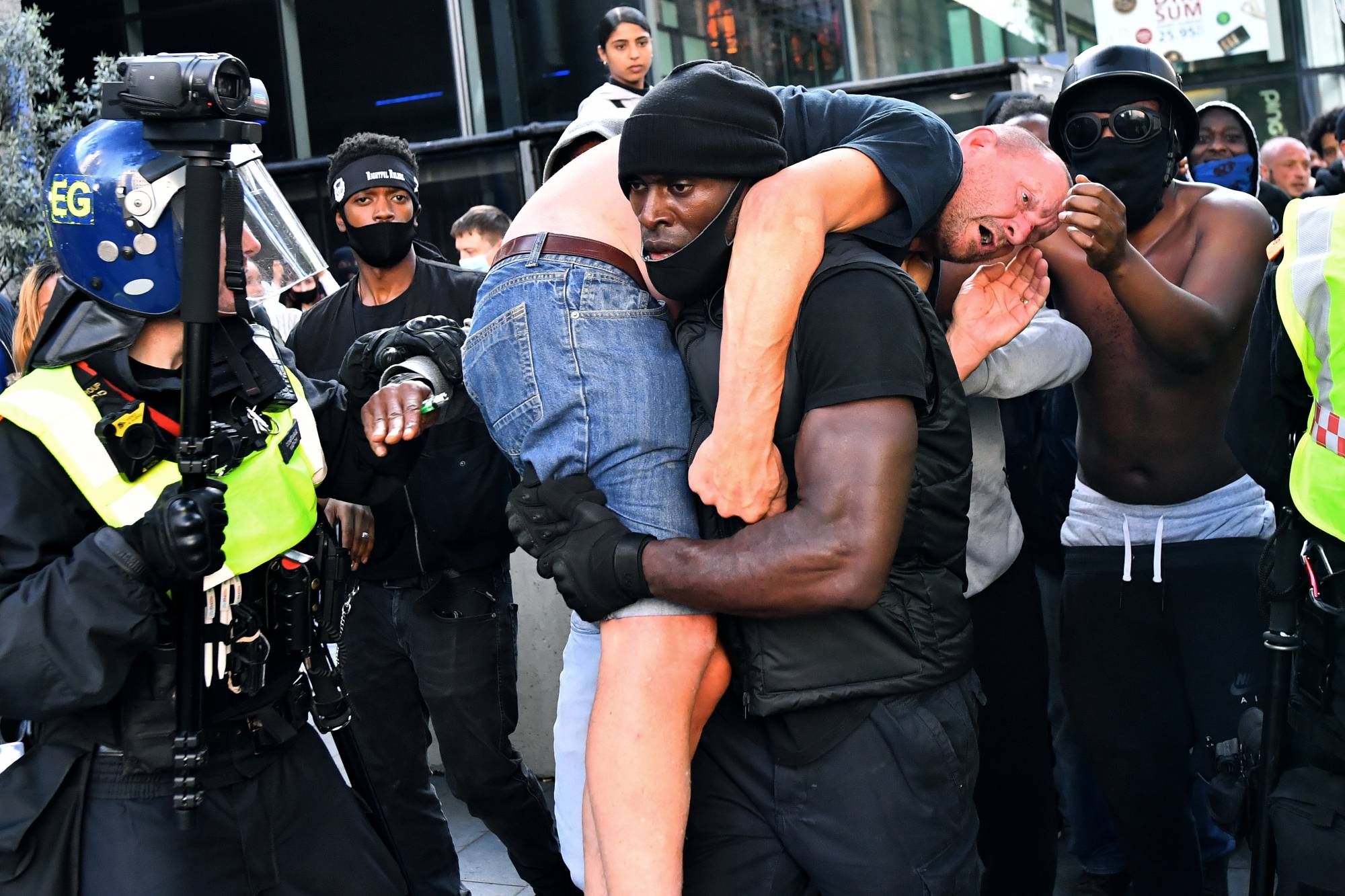 Man wearing a hooded top, sunglasses and Louis Vuitton Face Mask, at the  Black Lives Matter UK protest in Parliament Square. London, England UK  Stock Photo - Alamy