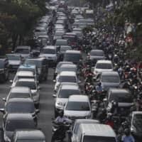 Jakarta partly reopened in early June after two months of partial lockdown, resulting in the return of crowded streets filled with rush hour traffic. | AP