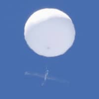 A white balloon-like object is seen floating in the sky over the city of Sendai on Wednesday morning. | KYODO
