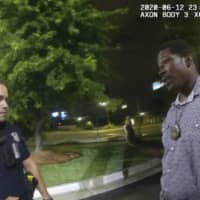 A screen grab taken from the body camera video provided by the Atlanta Police Department shows Rayshard Brooks speaking with officer Garrett Rolfe on Friday, the night Brooks was fatally shot.  | ATLANTA POLICE DEPARTMENT / VIA AP
