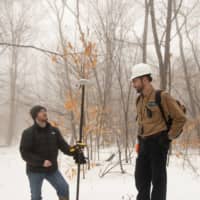 Timothy De Smet and Nathan Graber use a global navigation satellite system and geodetic antenna to locate an abandoned oil well in Olean, New York. | REUTERS 
