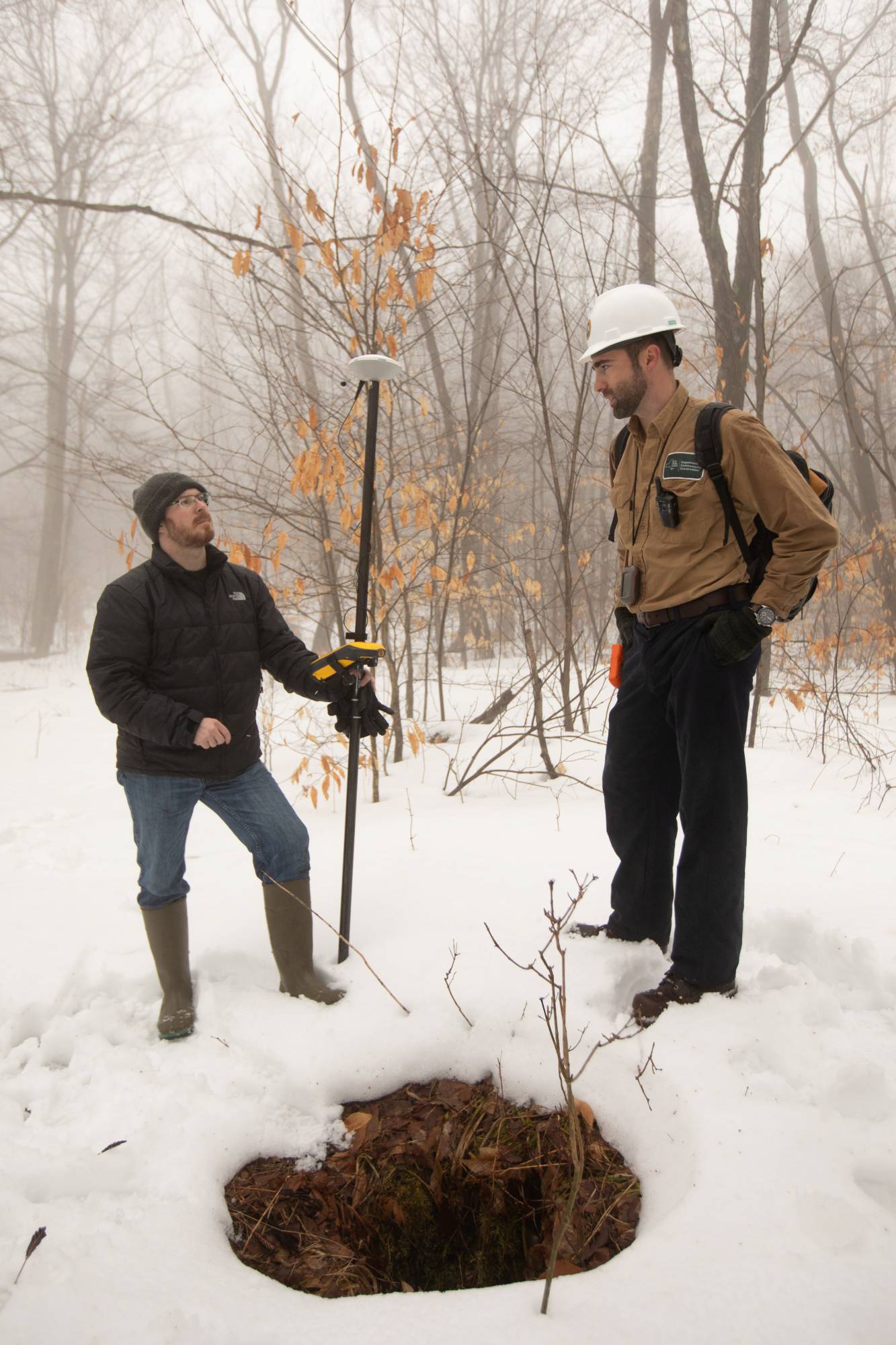 Timothy De Smet and Nathan Graber use a global navigation satellite system and geodetic antenna to locate an abandoned oil well in Olean, New York. | REUTERS 