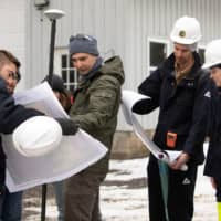 Nathan Graber and Charles Dietrich of the DEC display magnetic survey maps in Olean, New York.  | REUTERS 