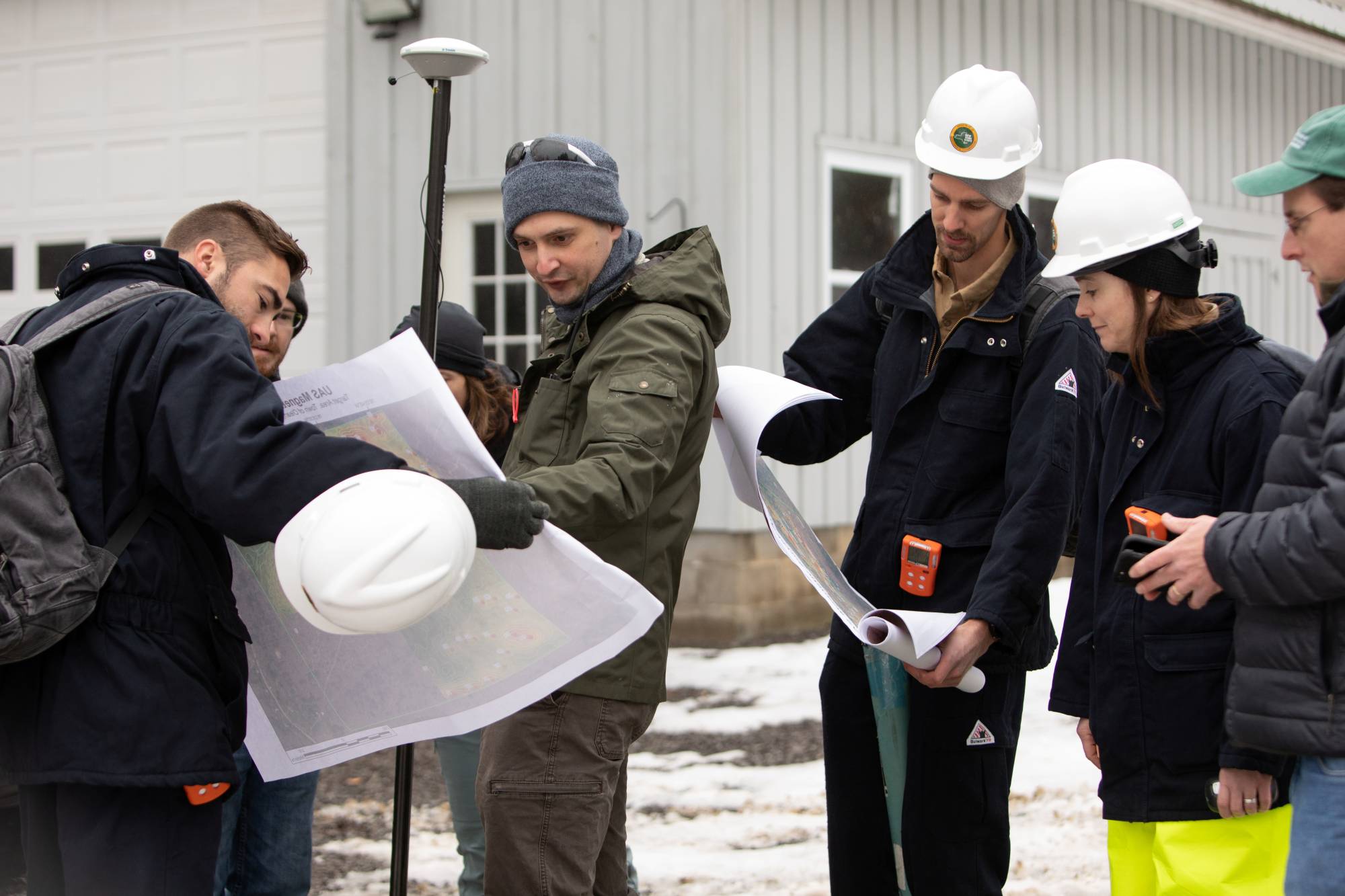 Nathan Graber and Charles Dietrich of the DEC display magnetic survey maps in Olean, New York. | REUTERS 