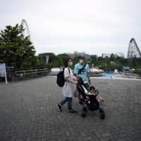A family visits the newly reopened Yomiuriland amusement park in Tokyo on Tuesday. | AP