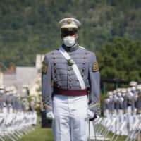 United States Military Academy graduating cadets wear face masks during commencement ceremonies last week. More U.S. states are mandating that people wear masks in public to curb the spread of the virus.  | POOL / VIA AP