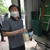 North Korean defector Park Jung-oh shows plastic bottles filled with rice and face masks as he prepares a plan to send the bottles toward North Korea via a river on the border, in Seoul on Thursday.  | AFP-JIJI