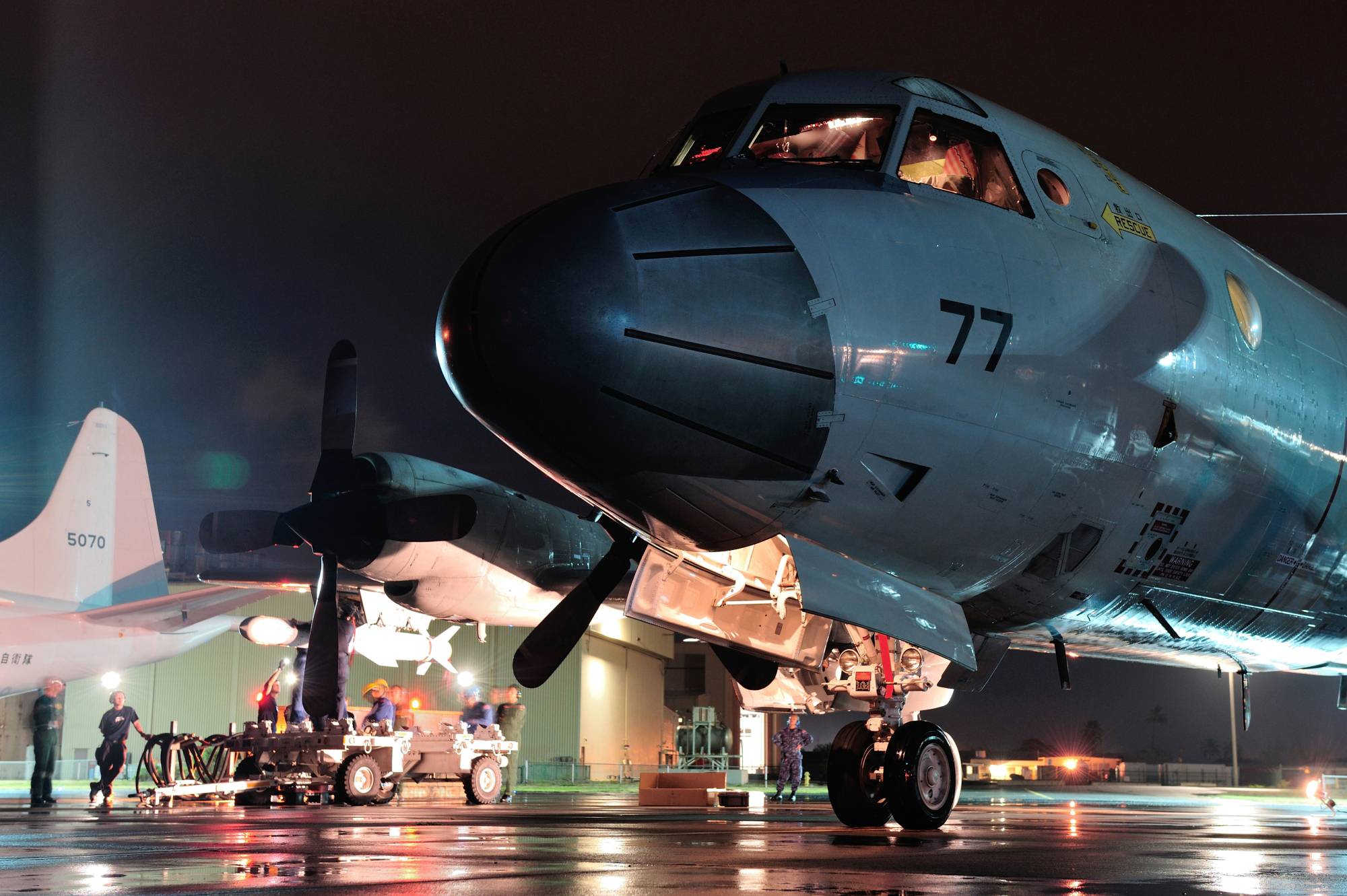 A Maritime Self-Defense Force P-3C Orion anti-submarine and maritime surveillance aircraft carries a Harpoon anti-ship missile as part of Rim of the Pacific (RIMPAC) exercise in Hawaii and California in 2014.  | MARITIME SELF-DEFENSE FORCE