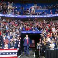 U.S. President Donald Trump walks toward the stage during his campaign rally at BOK Center in Tulsa, Oklahoma, on Saturday.  | TULSA WORLD / VIA AP