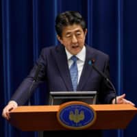 Prime Minister Shinzo Abe speaks during a news conference at his official residence in Tokyo on Thursday. | POOL / VIA AFP-JIJI