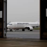 A Japan Airlines jet is seen at a maintenance center amid the coronavirus outbreak at Haneda Airport in Tokyo on May 26. | REUTERS