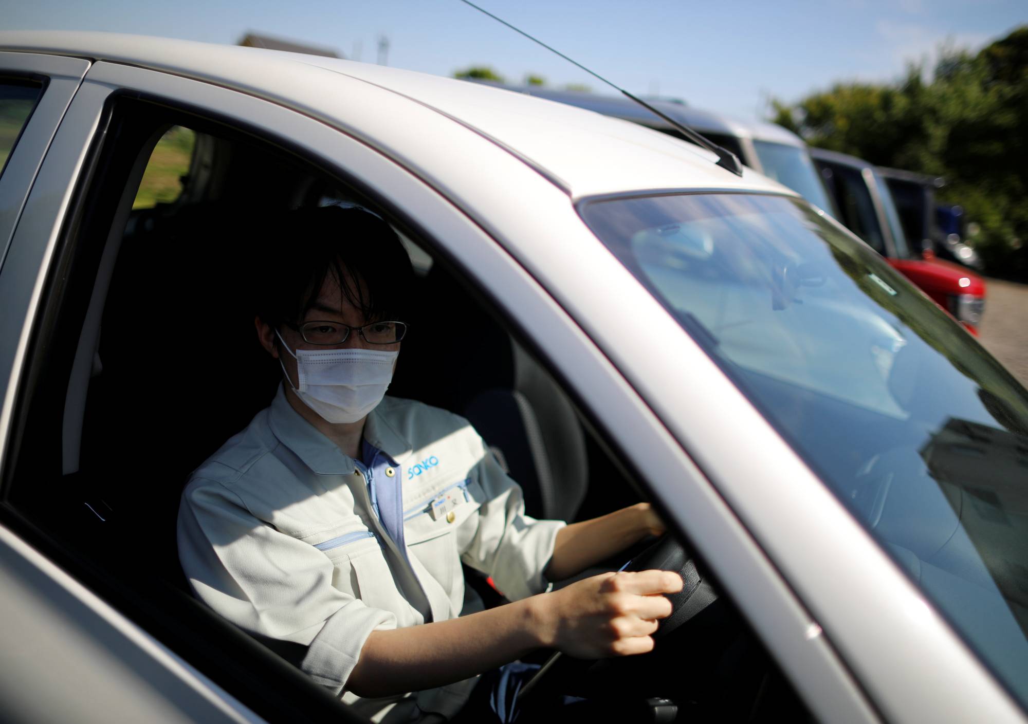 Ryota Kawamata says driving a rented car to work during the pandemic has motivated him to buy his own vehicle.  | REUTERS