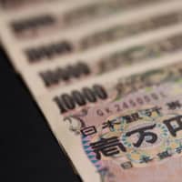 Japanese firms\' holding of too much cash is now touted as a reason to buy Japan stocks for better dividend returns. | BLOOMBERG