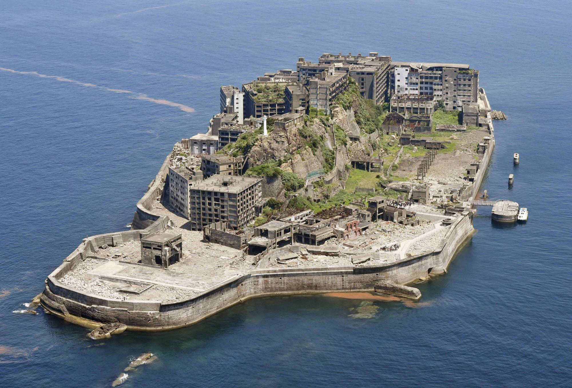 The Hashima Coal Mine in Nagasaki Prefecture, known as 'Battleship Island' because of its shape, is one of the 23 sites spanning eight prefectures that were added to the World Cultural Heritage list in 2015 under 'Sites of Japan's Meiji Industrial Revolution: Iron and Steel, Shipbuilding and Coal Mining.' | KYODO