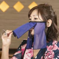 A model wearing kimono shows a Face Veil, a new type of protective mask co-developed by kimono-maker Otozuki and a nightclub operator. | OTOZUKI / VIA KYODO