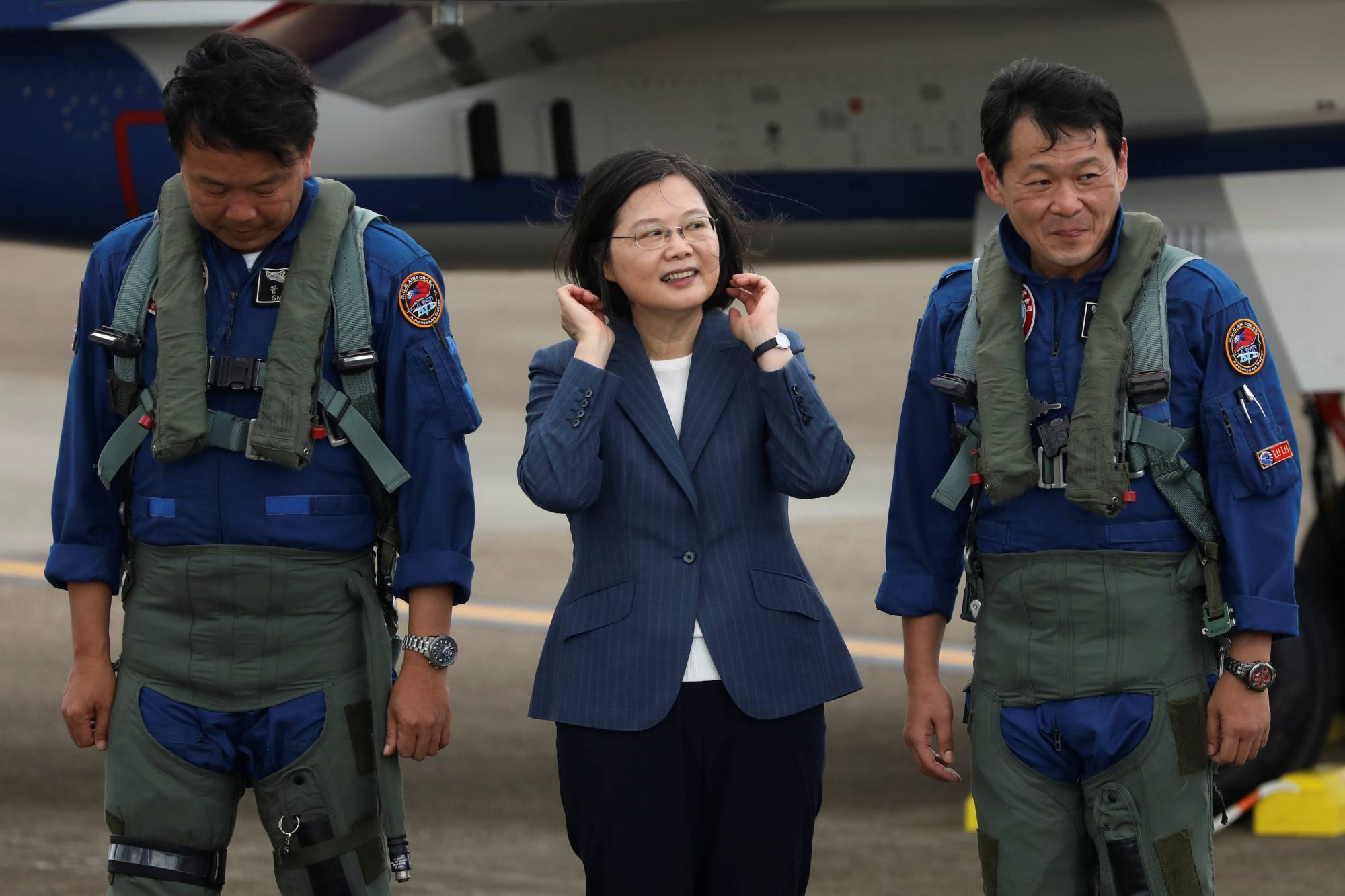 Taiwanese President Tsai Ing-Wen prepares to take photos with the pilots of an AIDC T-5 Brave Eagle, Taiwan's first locally manufactured advanced jet trainer, in Taichung on Monday.  | REUTERS 
