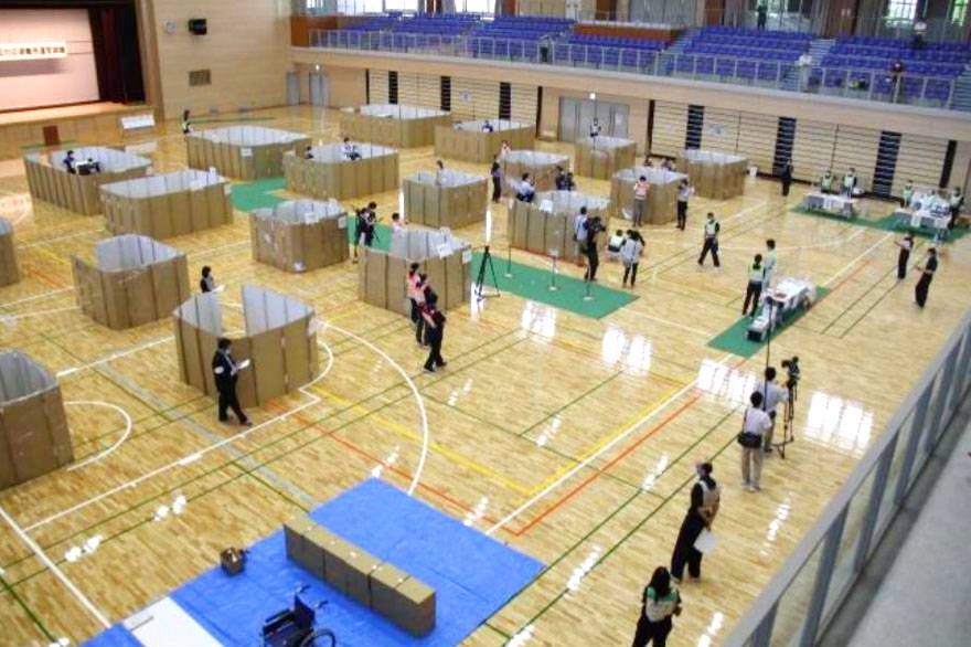Officials use cardboard to maintain social distancing during a drill to practice setting up an evacuation center in Mashiki, Kumamoto Prefecture, in May. | THE TOWN OF MASHIKI / VIA KYODO  