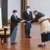 Emperor Naruhito (left) attends a ceremony to mark the arrivals of foreign envoys, including Tonga\'s new Ambassador Tevita Suka Mangisi (right) Wednesday at the Imperial Palace. | IMPERIAL HOUSEHOLD AGENCY / VIA KYODO